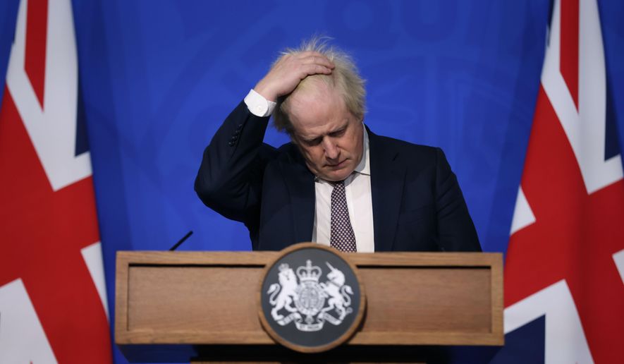Britain&#39;s Prime Minister Boris Johnson gestures as he speaks during a press conference in London, Saturday Nov. 27, 2021, after cases of the new COVID-19 variant were confirmed in the UK. British lawmakers will vote Tuesday, Dec. 14, 2921 on whether to approve new restrictions to curb the spread of the omicron variant of coronavirus — and many will have more than public health on their minds when they say yes or no. (Hollie Adams/Pool via AP, File)