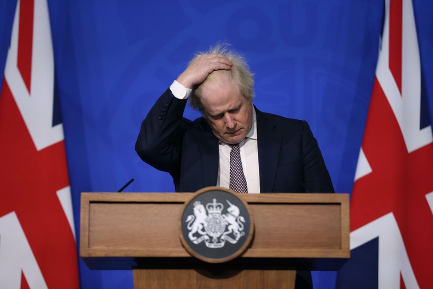 Britain's Prime Minister Boris Johnson gestures as he speaks during a press conference in London, Saturday Nov. 27, 2021, after cases of the new COVID-19 variant were confirmed in the UK. British lawmakers will vote Tuesday, Dec. 14, 2921 on whether to approve new restrictions to curb the spread of the omicron variant of coronavirus — and many will have more than public health on their minds when they say yes or no. (Hollie Adams/Pool via AP, File)