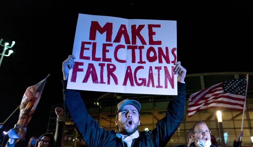 In this Nov. 5, 2020, file photo, Jake Contos, a supporter of President Donald Trump, chants during a protest against the election results outside the central counting board at the TCF Center in Detroit. (AP Photo/David Goldman, File)