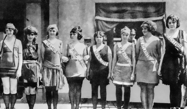 Contestants in the first Miss America pageant line up for the judges in Atlantic City, N.J., in September 1921. The competition is marking its 100th anniversary on Thursday, Dec. 16, 2021, having managed to maintain a complicated spot in American culture with a questionable relevancy. (AP Photo/File)  **FILE**