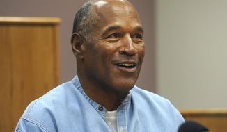 In this July 20, 2017, file photo, former NFL football star O.J. Simpson appears via video for his parole hearing at the Lovelock Correctional Center in Lovelock, Nev. The 74-year-old former football hero, acquitted California murder defendant and convicted Las Vegas armed robber was granted good behavior credits and discharged from parole effective Dec. 1, the day after a hearing before the Nevada state Board of Parole, Kim Yoko Smith, spokeswoman for the Nevada State Police, said Tuesday, Dec. 14, 2021. (Jason Bean/The Reno Gazette-Journal via AP, Pool, File)