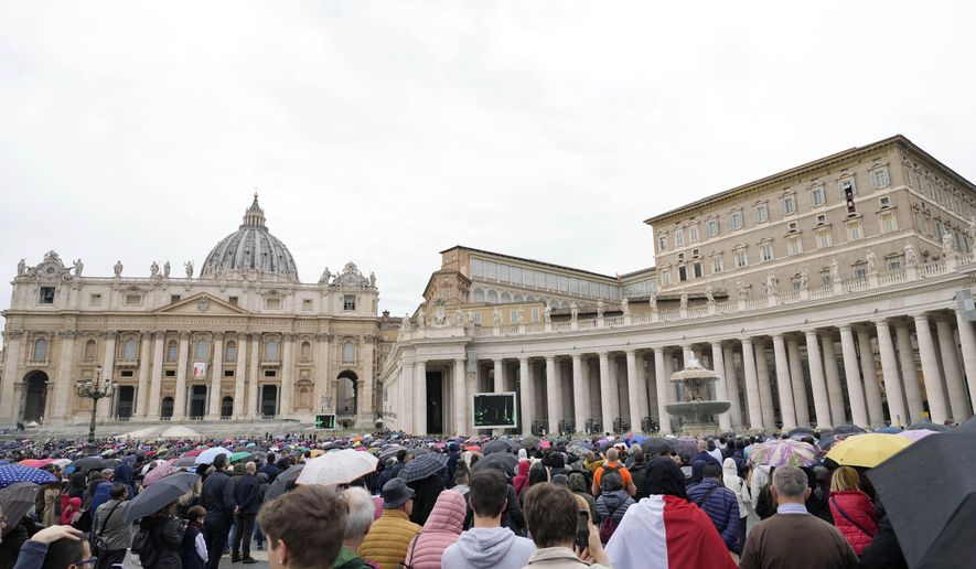 FILE - Faithful gather to listen to Pope Francis&#39; Angelus noon prayer in St. Peter&#39;s Square, at the Vatican, Sunday, Nov. 14, 2021. The Vatican’s big fraud and embezzlement trial, which opened to great fanfare in July, suffered another delay Tuesday, Dec. 14, 2021 as the tribunal postponed any further decisions until prosecutors finish redoing their investigation for four of the original 10 defendants.   (AP Photo/Gregorio Borgia, File)