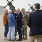 President Joe Biden greets Kentucky Gov. Andy Beshear, his wife Britainy Beshear, and former Gov. Steve Beshear, as he arrives in Fort Campbell, Ky., Wednesday, Dec. 15, 2021, to survey storm damage from tornadoes and extreme weather. (AP Photo/Andrew Harnik)