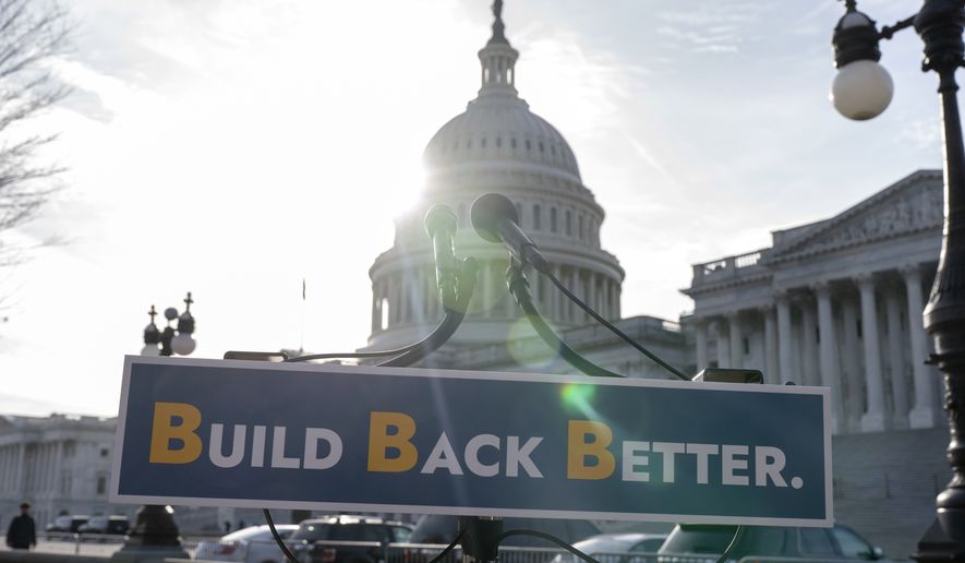 With the U.S. Capitol dome in the background, a sign that reads &quot;Build Bake Better&quot; is displayed before a news conference, Wednesday, Dec. 15, 2021, on Capitol Hill in Washington. (AP Photo/Jacquelyn Martin)