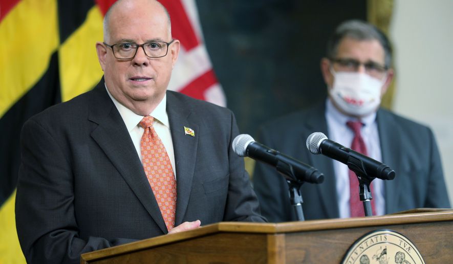 Maryland Gov. Larry Hogan speaks alongside Maryland Health Secretary Dennis Schrader during a news conference, Dec. 1, 2021 in Annapolis, Md. Gov. Hogan has announced additional actions to prepare for a further surge in COVID-19 hospitalizations. Hogan said Wednesday, Dec. 15, 2021 that state health officials have issued a new directive ordering hospitals to undertake actions when certain state COVID-19 hospitalization thresholds are reached. (AP Photo/Brian Witte, file)