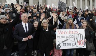 Robert F. Kennedy, Jr., left, stands with protesters at the Capitol in Olympia, Wash., on Feb. 8, 2019, where they opposed a bill to tighten measles, mumps and rubella vaccine requirements for school-aged children. He carved out a career as a bestselling author and top environmental lawyer fighting for important public health priorities such as clean water. His work as a leading voice in that movement likely would have been his legacy, but more than 15 years ago, he became fixated on a belief that vaccines are not safe, despite overwhelming scientific consensus that they are. (AP Photo/Ted S. Warren, File)