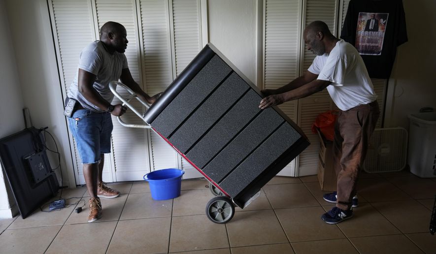 Cousin Johnny McGriff, left, and uncle Billy McGriff Sr. help move furniture for Freddie Davis, as Davis prepares for an eviction that could come at any time, Monday, Sept. 6, 2021, in the ground floor one-bedroom apartment where he has lived for almost four years, in Miami. Davis&#x27; landlord raised his rent by 60 percent in August 2020, the same month he lost his job as a truck driver when the company he worked for folded during the pandemic.  (AP Photo/Rebecca Blackwell) **FILE**