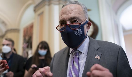 Senate Majority Leader Chuck Schumer, D-N.Y., emerges from a Democratic Caucus meeting as the Senate continues to grapple with end-of-year tasks at the Capitol in Washington, Thursday, Dec. 16, 2021. (AP Photo/J. Scott Applewhite)