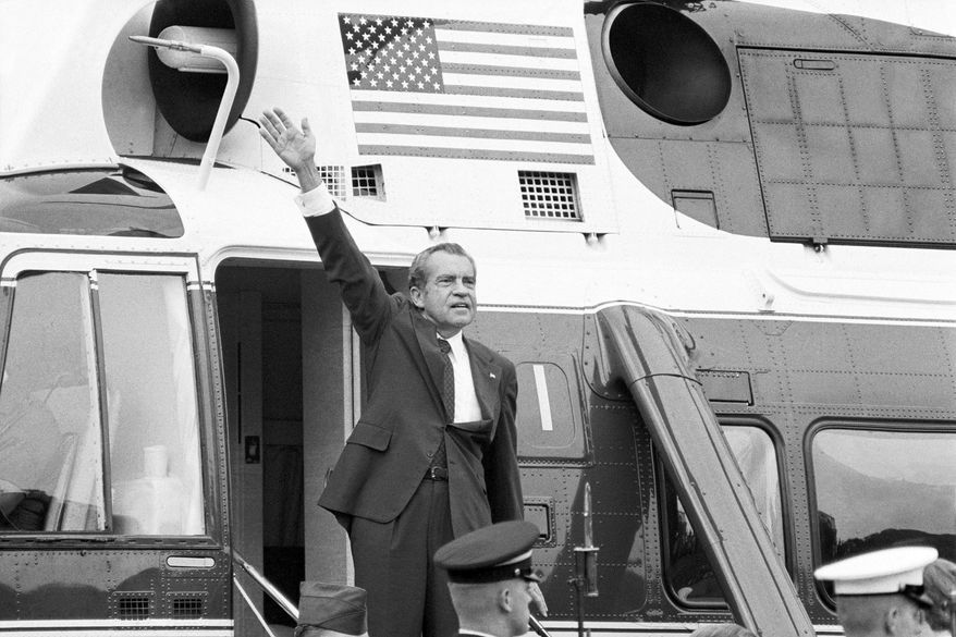 FILE - President Richard Nixon waves goodbye from the steps of his helicopter outside the White House, Aug. 9, 1974, after he gave a farewell address to members of the White House staff. (AP Photo/Chick Harrity, File)