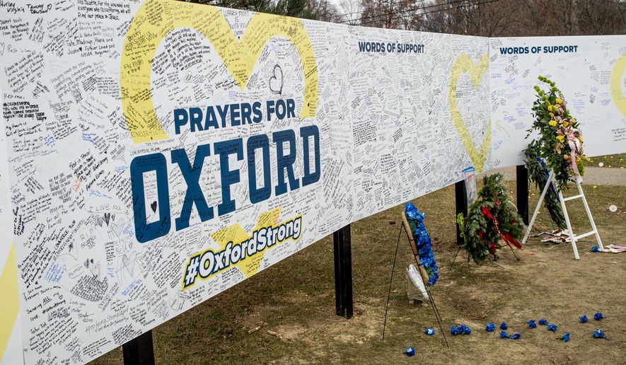 Handwritten messages are left at the memorial site on Tuesday, Dec. 7, 2021, outside Oxford High School in Oxford, Mich., after a 15-year-old allegedly killed these four classmates, and injured seven others in a shooting inside the northern Oakland County school one week earlier. School officials around the country are planning to step up security Friday in response to social media posts warning of violence. The anonymous threats on TikTok had many educators on edge because they are circulating in the aftermath of a deadly school shooting in Michigan.  (Jake May/The Flint Journal via AP, File)