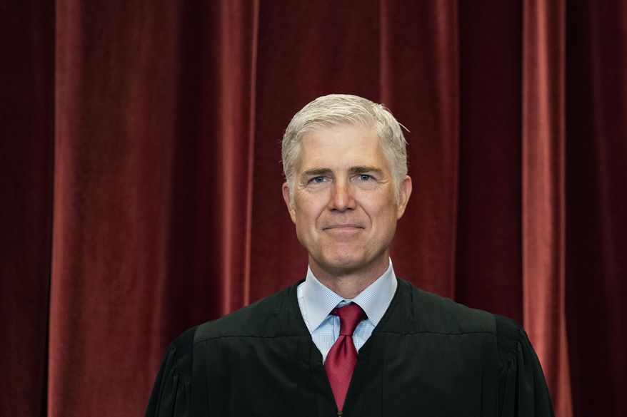 Associate Justice Neil Gorsuch stands during a group photo at the Supreme Court in Washington, April 23, 2021. (Erin Schaff/The New York Times via AP, Pool, File)