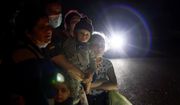 A group of migrants mainly from Honduras and Nicaragua wait along a road after turning themselves in upon crossing the U.S.-Mexico border, in La Joya, Texas, on May 17, 2021. (AP Photo/Gregory Bull, File)