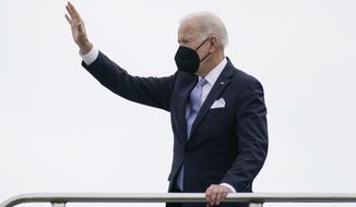 President Joe Biden waves as he boards Air Force One at Columbia Metropolitan Airport in West Columbia, S.C., en route to Philadelphia after speaking at the South Carolina State University&#39;s 2021 Fall Commencement Ceremony in Orangeburg, S.C., Friday, Dec. 17, 2021. (AP Photo/Carolyn Kaster)