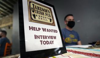 FILE - A hiring sign is shown at a booth for Jameson&#39;s Irish Pub during a job fair on Sept. 22, 2021, in the West Hollywood section of Los Angeles. Hiring in California slowed significantly in November 2021 even as the state&#39;s unemployment rate dipped below 7% for the first time since March 2020, at the start of the pandemic, according to data made public Friday, Dec. 17, 2021. (AP Photo/Marcio Jose Sanchez, File)