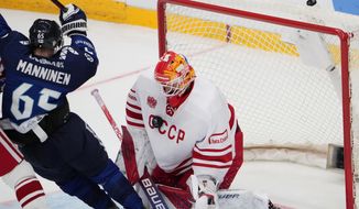 Russia&#39;s goalie Ivan Fedotov makes a save as Finland&#39;s Sekari Manninen tries to score during the Channel One Cup ice hockey match between Russia and Finland in Moscow, Russia, Sunday, Dec. 19, 2021. (AP Photo/Alexander Zemlianichenko)