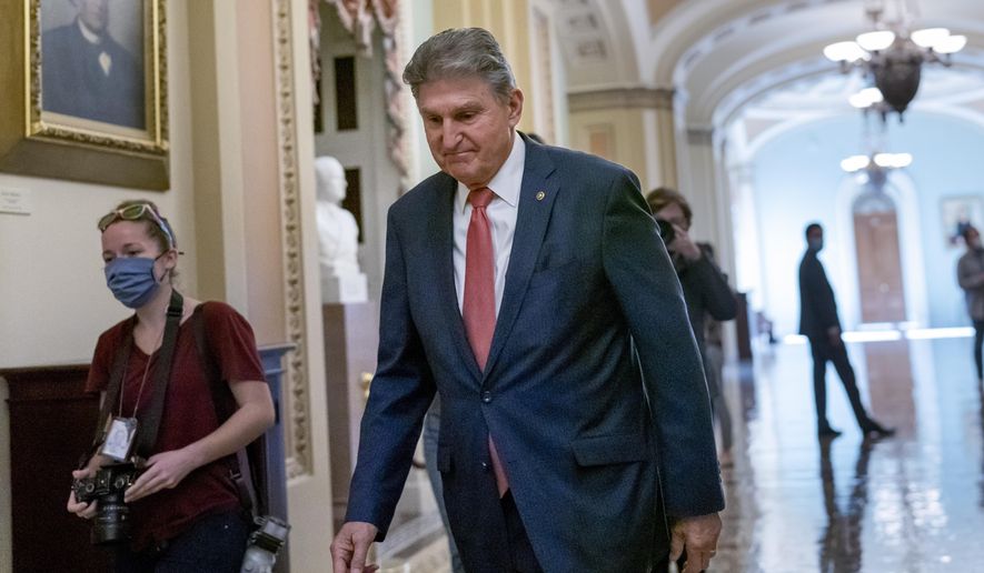 Sen. Joe Manchin, D-W.Va., a centrist Democrat vital to the fate of President Joe Biden&#x27;s $3.5 government overhaul, walks to a caucus lunch at the Capitol in Washington, Friday, Dec. 17, 2021. Despite months of being courted and cajoled, Manchin is still not a yes on President Joe Biden&#x27;s big $2 trillion domestic package and has thrown Democrats into turmoil. (AP Photo/J. Scott Applewhite)