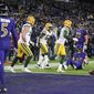 Members of the Green Bay Packers celebrate after a two-point conversion attempt to Baltimore Ravens tight end Mark Andrews, bottom right, failed in the second half of an NFL football game, Sunday, Dec. 19, 2021, in Baltimore. Green Bay won 31-30. (AP Photo/Nick Wass)