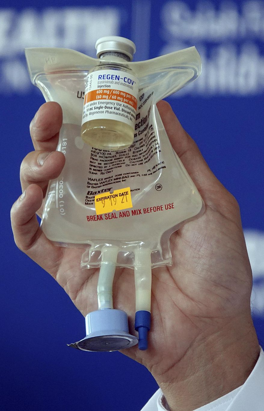 Dr. Aldo Calvo, Medical Director of Family Medicine at Broward Health, shows a Regeneron monoclonal antibody infusion bag during a news conference, Aug. 19, 2021, at the Hospital in Fort Lauderdale, Fla. As strained U.S. hospitals brace for a new surge of omicron COVID-19 cases, doctors are warning of yet another challenge: the two standard drugs they’ve used to treat early coronavirus infections are unlikely to work against the new variant. For more than a year antibody drugs from Regeneron and Eli Lilly have been the go-to treatments for COVID-19, thanks to their ability to head off severe disease and keep patients out of the hospital. (Joe Cavaretta/South Florida Sun-Sentinel via AP) **FILE**