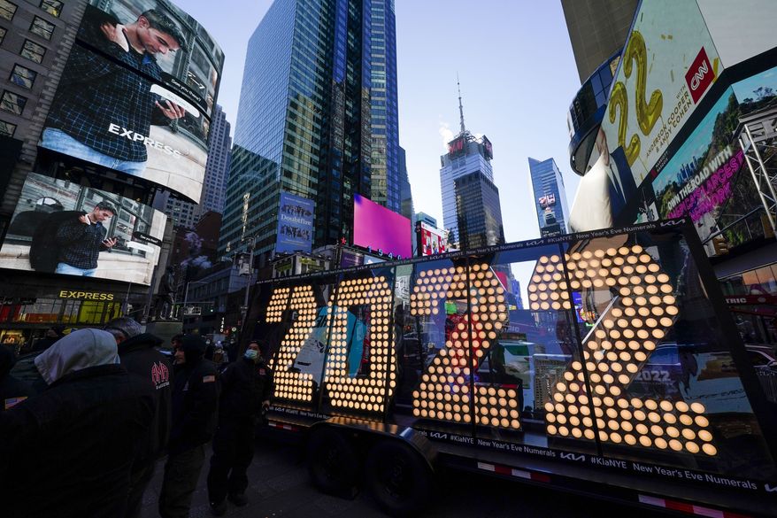 The 2022 sign that will be lit on top of a building on New Year's Eve is displayed in Times Square, New York, Monday, Dec. 20, 2021. Crowds will once again fill New York's Times Square this New Year's Eve, with proof of COVID-19 vaccination required for revelers who want to watch the ball drop in person, Mayor Bill de Blasio announced last week. (AP Photo/Seth Wenig)