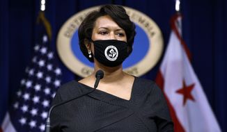 District of Columbia Mayor Muriel Bowser wears a face mask, as she speaks at a news conference on the coronavirus and the District&#39;s response, July 13, 2020, in Washington. The nation’s capital is reinstating its indoor mask mandate as the region and country grapple with a fresh surge in COVID-19 infections. (AP Photo/Patrick Semansky, File)