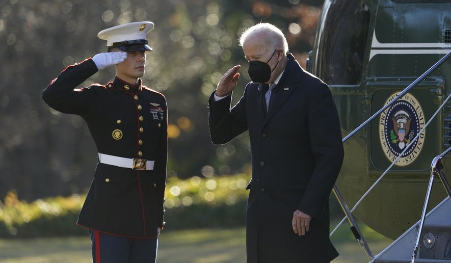In this file photo, President Joe Biden salutes as he steps off Marine One on the South Lawn of the White House in Washington, Monday, Dec. 20, 2021. Biden is returning to Washington after spending the weekend at his home in Delaware. (AP Photo/Patrick Semansky)