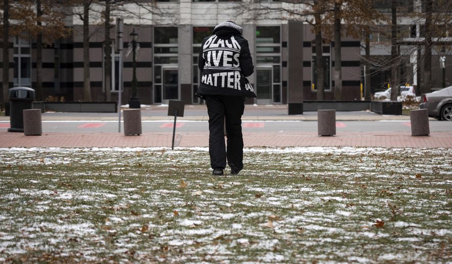 A demonstrator wears a Black Lives Matter jacket outside of the Hennepin County Courthouse during the trial of former Brooklyn Center police Officer Kim Potter, Friday Dec. 17, 2021, in Minneapolis. Potter, who is white, is charged with first- and second-degree manslaughter in the shooting of Daunte Wright, a Black motorist, in the suburb of Brooklyn Center. Potter has said she meant to use her Taser – but grabbed her handgun instead – after Wright tried to drive away as officers were trying to arrest him. (AP Photo/Christian Monterrosa) **FILE**