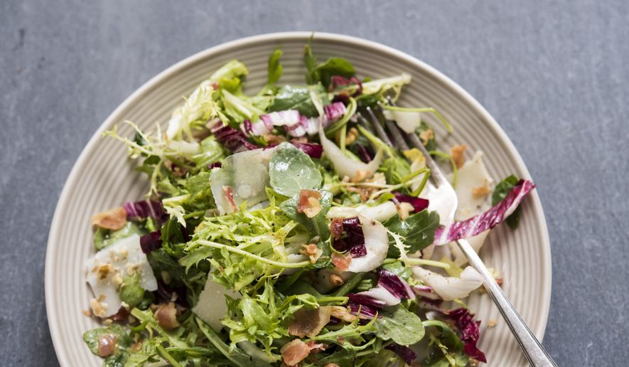 This image released by Milk Street shows a recipe for greens with walnuts, parmesan and pancetta vin. (Milk Street via AP)