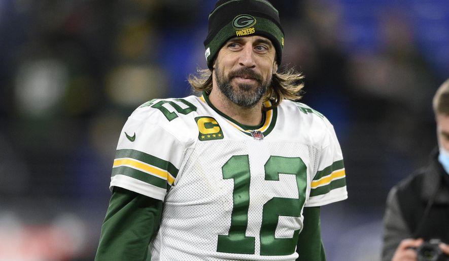Green Bay Packers quarterback Aaron Rodgers (12) walks on the field after an NFL football game against the Baltimore Ravens, Sunday, Dec. 19, 2021, in Baltimore. (AP Photo/Nick Wass)