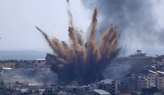 In this file photo, a blast from an Israeli airstrike on a building in Gaza City throws dust and debris on May 13, 2021, as Hamas and Israel traded more rockets and airstrikes and Jewish-Arab violence raged across Israel at the end of the Muslim holy month of Ramadan. Israel’s military said early Sunday, Jan. 2, 2022 that it launched strikes against militant targets in the Gaza Strip, a day after rockets were fired from the Hamas-ruled territory. (AP Photo/Hatem Moussa)  **FILE**