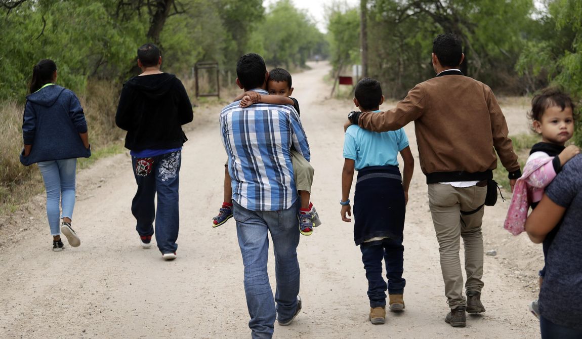 A group of migrant families walk from the Rio Grande, the river separating the U.S. and Mexico in Texas, near McAllen, Texas, March 14, 2019. A Biden administration effort to reunite children and parents who were separated under President Donald Trump&#x27;s zero-tolerance border policy has made increasing progress as it nears the end of its first year. The Department of Homeland Security planned Thursday, Dec. 23, to announce that 100 children, mostly from Central America, are back with their families and about 350 more reunifications are in process after it adopted measures to enhance the program. (AP Photo/Eric Gay, File)