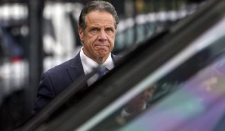 New York Gov. Andrew Cuomo prepares to board a helicopter after announcing his resignation, on Aug. 10, 2021, in New York. Cuomo won&#39;t face criminal charges after a female state trooper said she felt “completely violated” by his unwanted touching at an event at Belmont Park in September 2019, a Long Island prosecutor said Thursday, Dec. 23, 2021. Acting Nassau County District Attorney Joyce Smith said in a statement that an investigation found the allegations against Cuomo “credible, deeply troubling, but not criminal under New York law.” (AP Photo/Seth Wenig, File)
