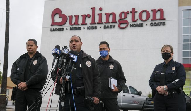 Los Angeles Police Department PIO Capt. Stacy Spell, second from left, speaks in a press conference at the scene where two people were struck by gunfire in a shooting at the Burlington Coat Factory store in North Hollywood, Calif., Thursday, Dec. 23, 2021. (AP Photo/Ringo H.W. Chiu)