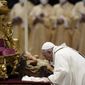 Pope Francis kisses a statue of Baby Jesus as he celebrates Christmas Eve Mass, at St. Peter&#39;s Basilica, at the Vatican, Friday Dec. 24, 2021. Pope Francis is celebrating Christmas Eve Mass before an estimated 1,500 people in St. Peter’s Basilica. He&#39;s going ahead with the service despite the resurgence in COVID-19 cases that has prompted a new vaccine mandate for Vatican employees. (AP Photo/Alessandra Tarantino)