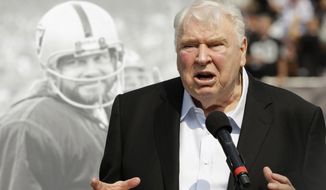 Former Oakland Raiders head coach John Madden speaks about former quarterback Ken Stabler, pictured at rear, at a ceremony honoring Stabler during halftime of an NFL football game between the Raiders and the Cincinnati Bengals in Oakland, Calif., on Sept. 13, 2015. (AP Photo/Ben Margot) **FILE**
