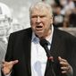 Former Oakland Raiders head coach John Madden speaks about former quarterback Ken Stabler, pictured at rear, at a ceremony honoring Stabler during halftime of an NFL football game between the Raiders and the Cincinnati Bengals in Oakland, Calif., on Sept. 13, 2015. (AP Photo/Ben Margot) **FILE**