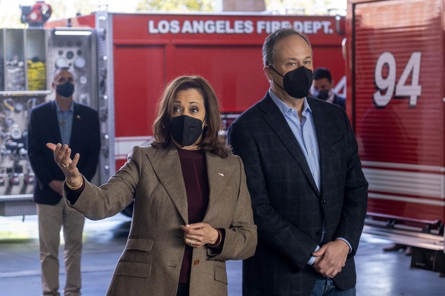 Vice President Kamala Harris, left, wearing a face mask, accompanied by her husband, Douglas Emhoff, speaks with firefighters while visiting the Los Angeles Fire Department Station 94, in Los Angeles, Friday, Dec. 24, 2021. (AP Photo/Ringo H.W. Chiu) ** FILE **