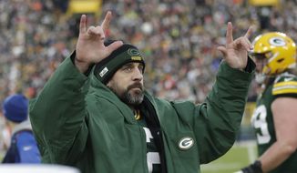 Green Bay Packers&#39; Aaron Rodgers celebrates after throwing career touchdown pass 443 during the first half of an NFL football game against the Cleveland Browns Saturday, Dec. 25, 2021, in Green Bay, Wis. The pass breaks the previous Green Bay Packers record held by Brett Favre. (AP Photo/Aaron Gash) **FILE**