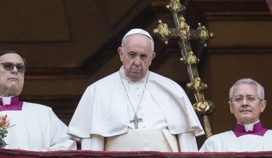 Pope Francis looks at the crowd after delivering the Urbi et Orbi (Latin for 'to the city and to the world' ) Christmas' day blessing from the main balcony of St. Peter's Basilica at the Vatican, Saturday, Dec. 25, 2021. (AP Photo/Gregorio Borgia)