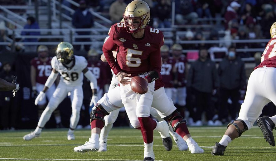 FILE - Boston College quarterback Phil Jurkovec (5) prepares to hand the ball off during the second half of an NCAA college football game against Wake Forest, Saturday, Nov. 27, 2021, in Boston. The Fenway Bowl and Military Bowl have been canceled due to the pandemic as coronavirus outbreaks at Virginia and Boston College forced them to call off their postseason plans.  The Military Bowl scheduled for Monday, Dec. 27,  at Navy-Marine Corps Memorial Stadium between Boston College and Eastern Carolina was canceled because of positive COVID-19 tests at BC.(AP Photo/Mary Schwalm, File)
