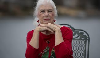 Wanda Olson poses for a photo, Friday, Dec. 17, 2021, in Villa Rica, Ga. When Olson’s son-in-law died in March after contracting COVID-19, she and her daughter had to grapple with more than just their sudden grief. They had to come up with money for a cremation. Even without a funeral, the bill came to nearly $2,000, a hefty sum that Olson initially covered. (AP Photo/Mike Stewart)