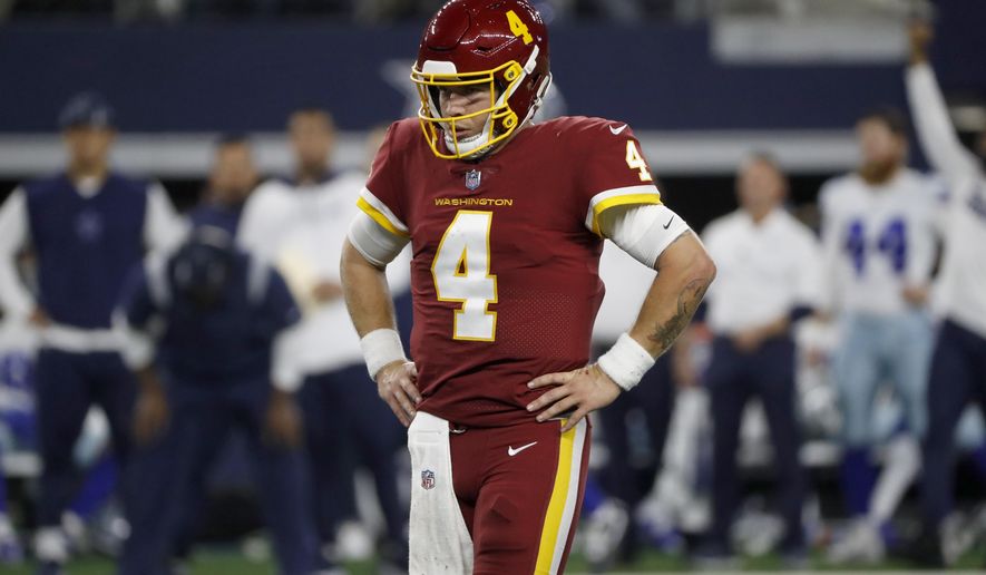 Washington Football Team quarterback Taylor Heinicke (4) stands on the field between plays in the second half of an NFL football game against the Dallas Cowboys in Arlington, Texas, Sunday, Dec. 26, 2021. (AP Photo/Roger Steinman)