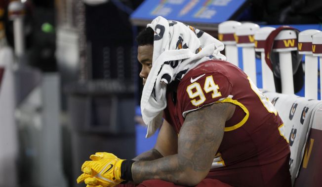 Washington Football Team defensive tackle Daron Payne sits on the bench in the second half of an NFL football game against the Dallas Cowboys in Arlington, Texas, Sunday, Dec. 26, 2021. (AP Photo/Roger Steinman) ** FILE**