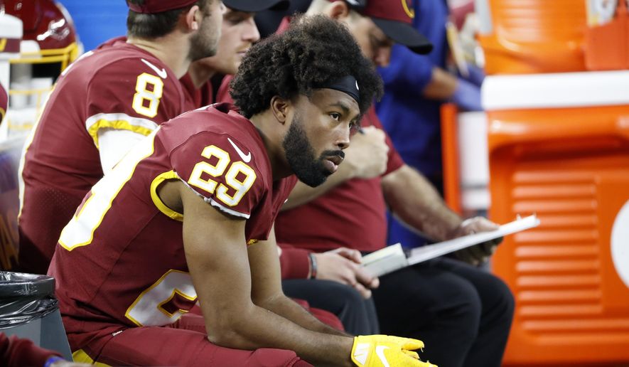 Washington Football Team cornerback Kendall Fuller (29) sits on the bench late in the second half of an NFL football game against the Dallas Cowboys in Arlington, Texas, Sunday, Dec. 26, 2021. (AP Photo/Roger Steinman)