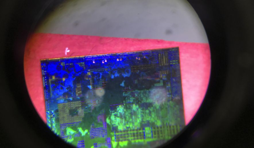 A Chinese microchip is seen through a microscope set up at the booth for the state-controlled Tsinghua Unigroup project which is driving China&#39;s semiconductor ambitions during the 21st China Beijing International High-tech Expo in Beijing, China, on May 17, 2018. Chips are a top priority in the ruling Communist Party&#39;s marathon campaign to end China&#39;s reliance on technology from the United States, Japan and other suppliers Beijing sees as potential economic and strategic rivals. If it succeeds, business and political leaders warn that might slow down innovation, disrupt global trade and make the world poorer. (AP Photo/Ng Han Guan, File)