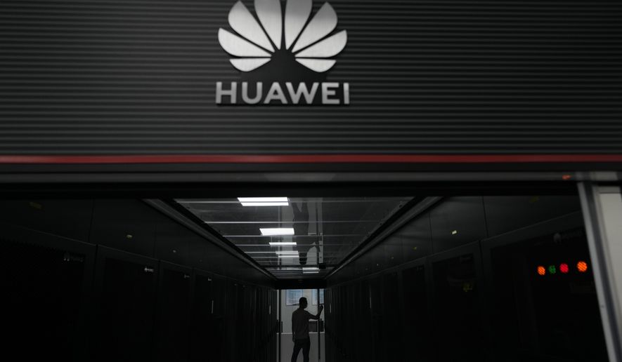A technician stands at the entrance to a Huawei 5G data server center at the Guangdong Second Provincial General Hospital in Guangzhou, in southern China&#x27;s Guangdong province  on Sept. 26, 2021. Chips are a top priority in the ruling Communist Party&#x27;s marathon campaign to end China&#x27;s reliance on technology from the United States and official urgency over that grew after Huawei Technologies Ltd., China&#x27;s first global tech brand, lost access to U.S. chips and other technology in 2018 under sanctions imposed by the White House. (AP Photo/Ng Han Guan)