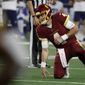 Washington Football Team quarterback Taylor Heinicke (4) gets up slowly after taking a hard hit in the second half of an NFL football game against the Dallas Cowboys in Arlington, Texas, Sunday, Dec. 26, 2021. (AP Photo/Roger Steinman) **FILE**