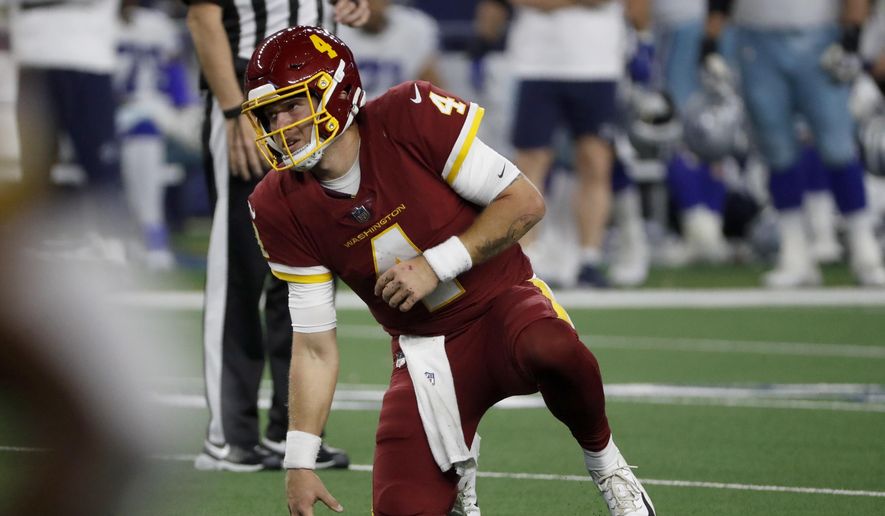 Washington Football Team quarterback Taylor Heinicke (4) gets up slowly after taking a hard hit in the second half of an NFL football game against the Dallas Cowboys in Arlington, Texas, Sunday, Dec. 26, 2021. (AP Photo/Roger Steinman) **FILE**