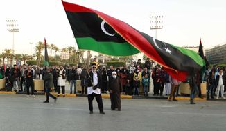 Libyans celebrate the 70th anniversary of their country&#39;s independence, despite widespread disappointment over the postponement of the presidential elections, which were scheduled to take place on the same day, in Martyrs&#39; Square, Tripoli, Libya, Friday, Dec. 24, 2021. (AP Photo/Yousef Murad)