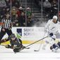 Vegas Golden Knights center Mattias Janmark (26) eyes the puck after colliding withTampa Bay Lightning center Steven Stamkos (91) during the third period of an NHL hockey game Tuesday, Dec. 21, 2021, in Las Vegas. (AP Photo/L.E. Baskow) **FILE**