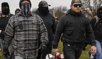 Proud Boys members Joseph Biggs, left, and Ethan Nordean, right with megaphone, walk toward the U.S. Capitol in Washington, Jan. 6, 2021. A federal judge on Tuesday, Dec. 28 refused to dismiss an indictment charging four alleged leaders of the far-right Proud Boys, Ethan Nordean, Joseph Biggs, Zachary Rehl and Charles Donohoe, with conspiring to attack the U.S. Capitol to stop Congress from certifying President Joe Biden&#39;s electoral victory. (AP Photo/Carolyn Kaster, File)